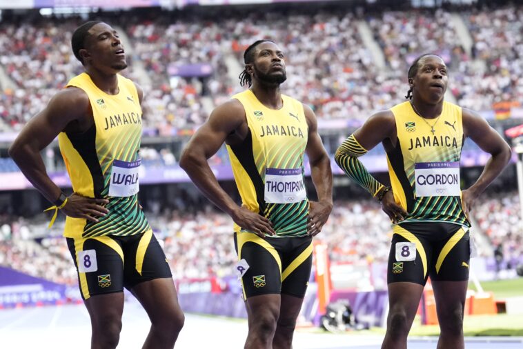 Kishane Thompson reflects with his teammates after the 4x100m relay at the 2024 Olympic Games.