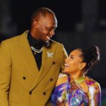 Usain Bolt looks lovingly at his partner, Kasi Bennett.