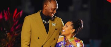 Usain Bolt looks lovingly at his partner, Kasi Bennett.