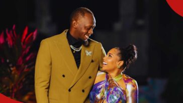 Usain Bolt looks lovingly at his partner, Kasi Bennett.