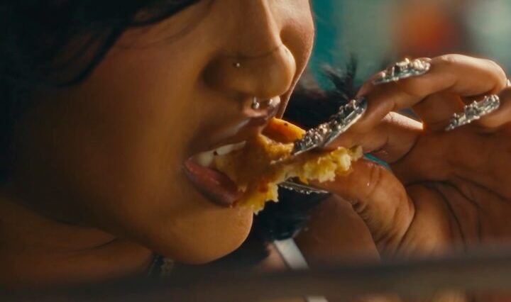 Stalk Ashley eats chicken during a scene in her 'Quaker' music video