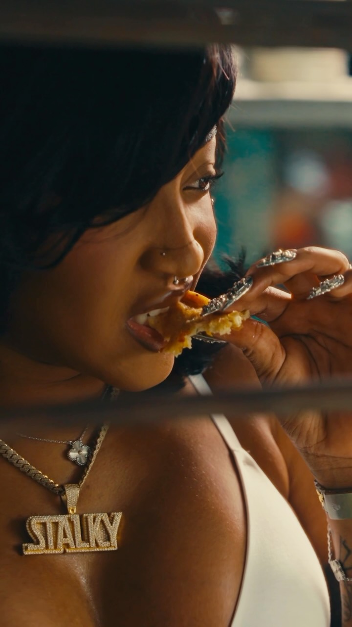 Stalk Ashley eats chicken during a scene in her 'Quaker' music video