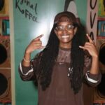 Koffee is all smiles while chilling on the endz by the stereo