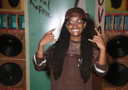 Koffee is all smiles while chilling on the endz by the stereo
