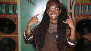 Koffee is all smiles while chilling on the endz by the stereo