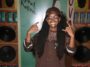 Koffee is all smiles while chilling on the endz by the stereo