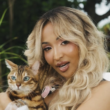 Shenseea pets a cat in her music video for 'Tightness.'