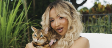 Shenseea pets a cat in her music video for 'Tightness.'