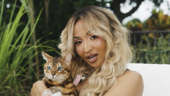 Shenseea pets a cat in her music video for 'Tightness.'