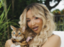 Shenseea pets a cat in her music video for 'Tightness.'