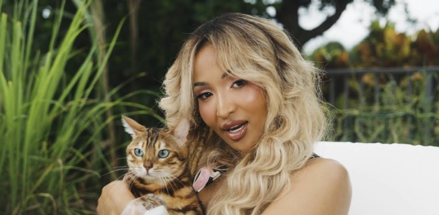 Shenseea pets a cat in her music video for 'Tightness.'