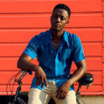 Reggae star Romain Virgo chills on his bike during his music video for 'No Substitute.'