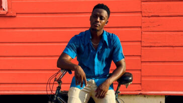 Reggae star Romain Virgo chills on his bike during his music video for 'No Substitute.'